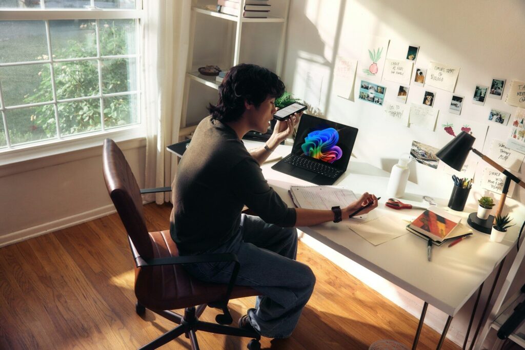 Person working at a desk with a laptop and books